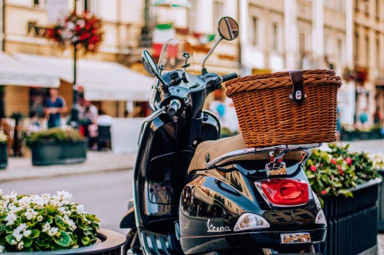 Un scooter gare avec un panier a larriere